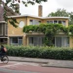 Van Ravesteyn House, het museum vanuit een voor aazicht, en twee fietsen die langs fietsen